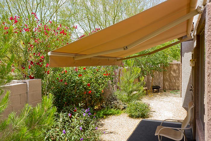 yellow retractable awning attached to house
