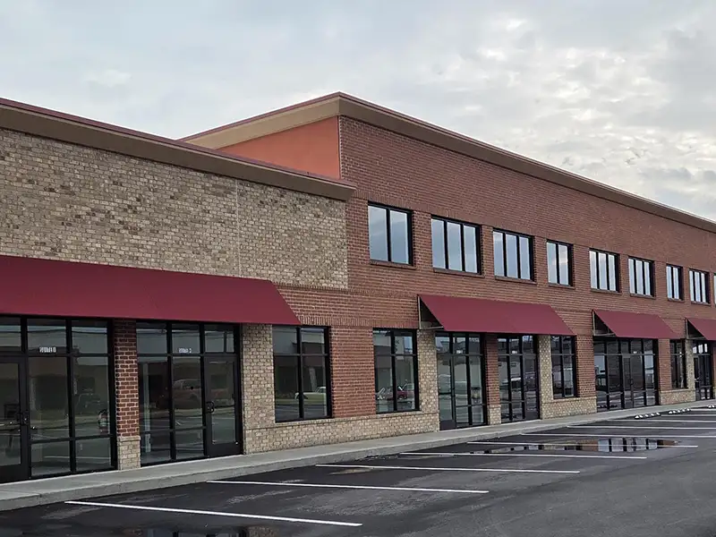 fabric awnings over doors on commercial storefront