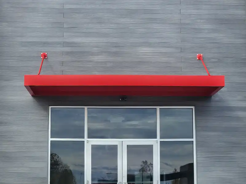 rod-hung red awning on commercial building entrance