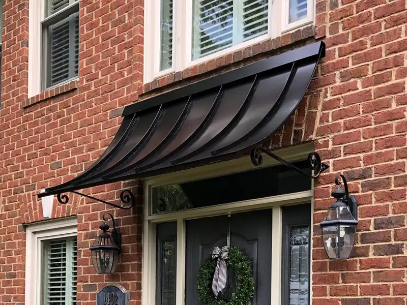 concave awning on residential brick home