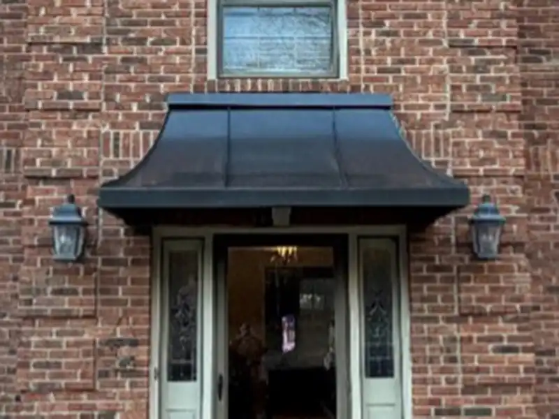 Juliet awning on residential brick home